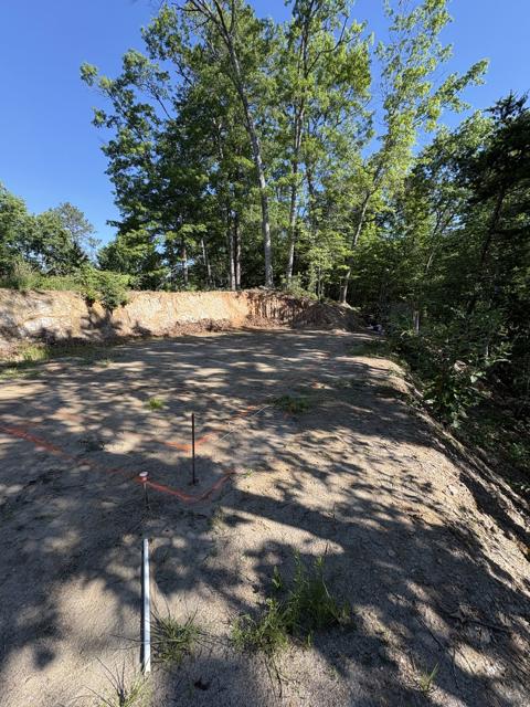 Stakes and string lines mark the squared footprint on the pad.